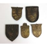 A collection of WWII Third Reich campaign shield badges to include Crimea, Kuban, Balkan and