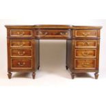 A 19th century walnut and parcel gilt twin pedestal desk, the tooled leather top over a bow front