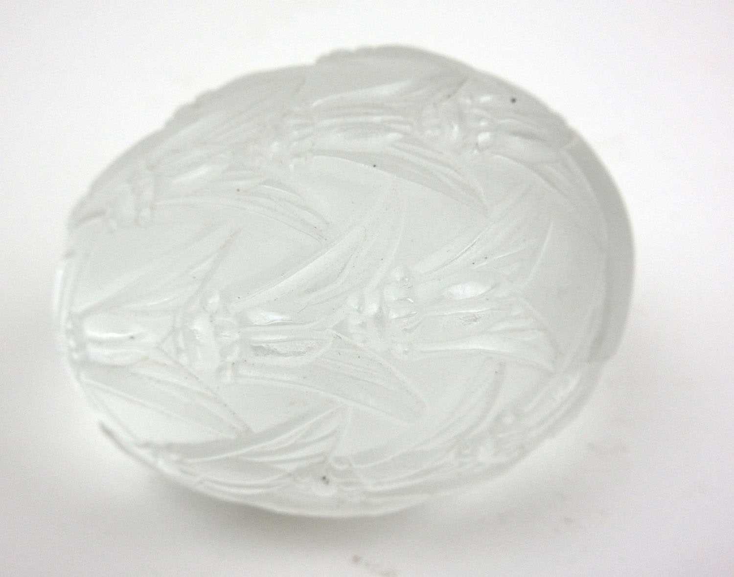 A Lalique glass paperweight of egg shaped form, decorated with a repeating pattern of insects, l.