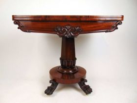 An early Victorian mahogany tea table, the fold over top supported on a swivel action over a