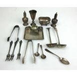 A collection of silver and white metal items to include pepper pots, dish, open salts, cup etc.