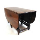 An early 18th century and later oak drop leaf table, the top supported on a double gate action