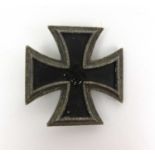 A (probably reproduction) WWII German Third Reich iron cross (first class). Stamped to pin, number