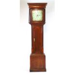 An 18th century oak and mahogany banded long case clock, the enameled face with Arabic numerals,