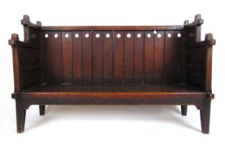 A late 19th century oak Arts and Crafts child's settle, 77 cm, w. 125 cm, d. 45 cmNo pad seat.