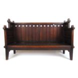 A late 19th century oak Arts and Crafts child's settle, 77 cm, w. 125 cm, d. 45 cmNo pad seat.