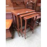 A nest of three Edwardian mahogany satinwood banded tables