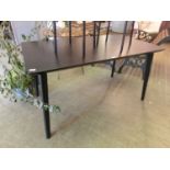 An ebonised kitchen table