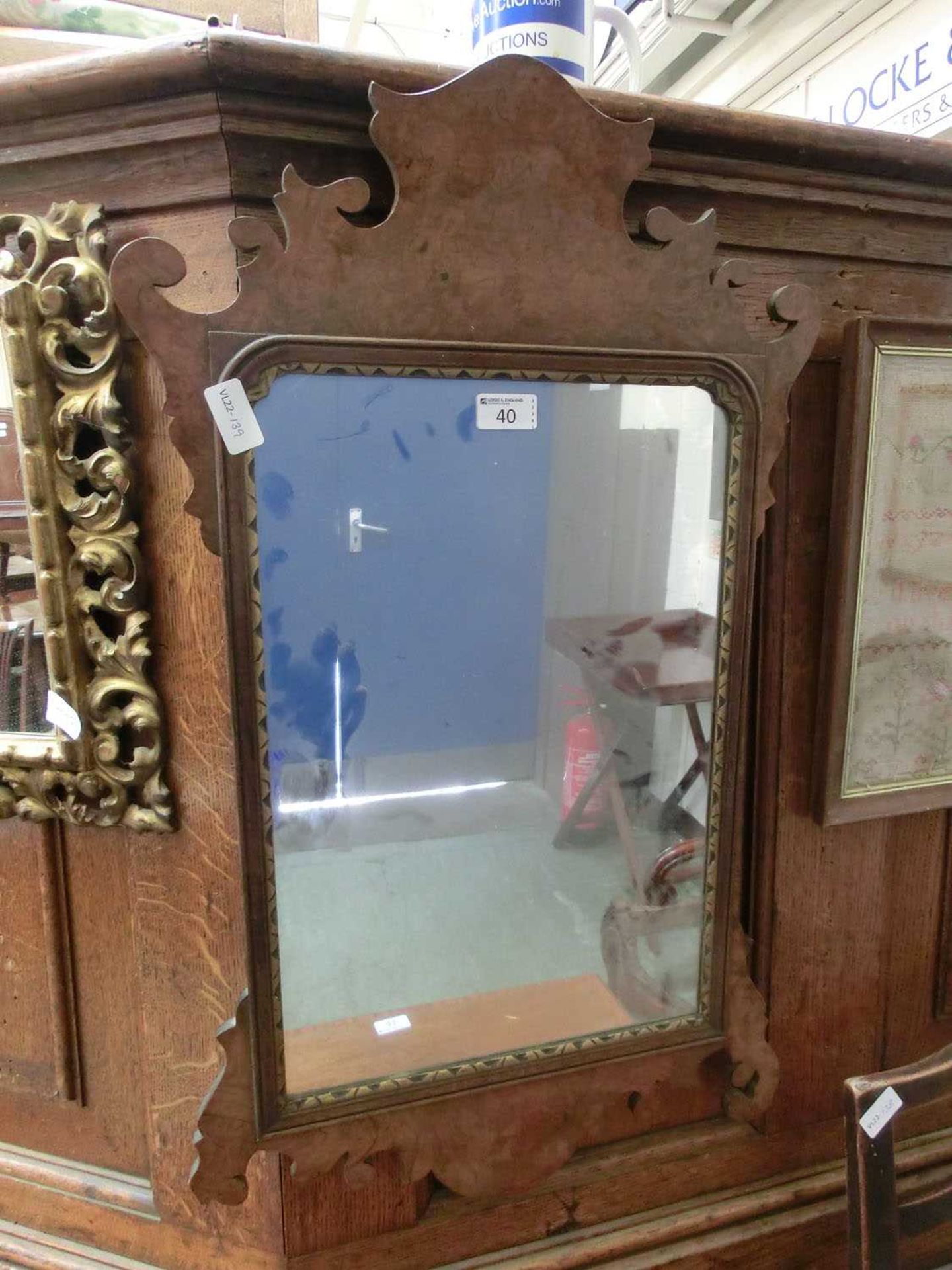 An early 20th century burr walnut Georgian style fretwork mirror