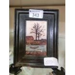 A framed wax carving of tree and lake scene