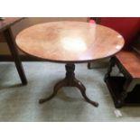 An 18th century oak tilt top pedestal table