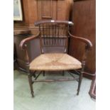 An early 19th century simulated rosewood open armchair with rush seat, h. 84 cm, w. 59 cm, d. 56 cm