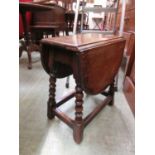 An early 20th century oak drop-leaf table of small proportiions