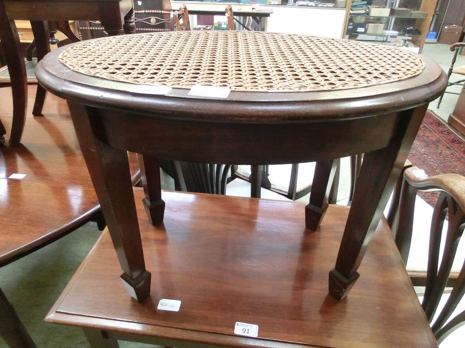 A Victorian mahogany oval stool with bergère seat