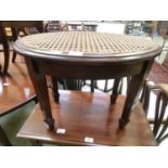 A Victorian mahogany oval stool with bergère seat