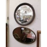 An oval metalwork framed mirror along with a circular bevel glass mirror