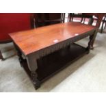 A reproduction oak rectangular table with under tier