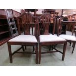A pair of Edwardian mahogany dining chairs with drop-in seats