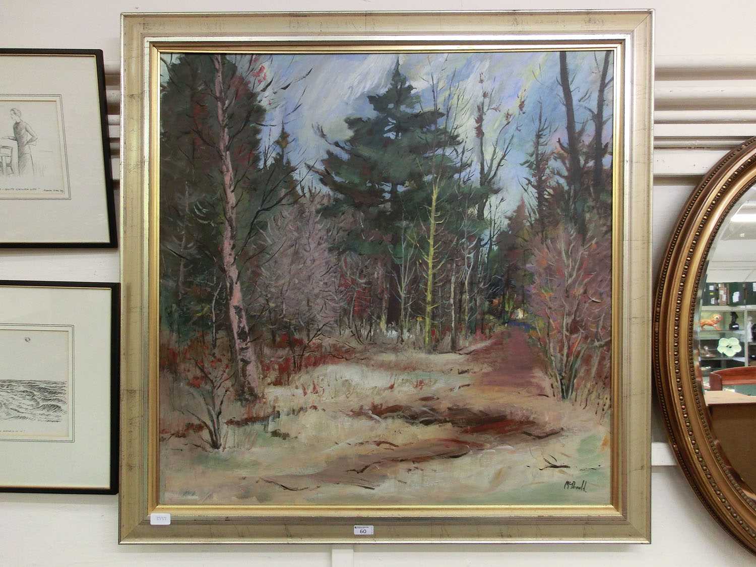A large framed oil on board of a wooded scene signed Jeff McDonald