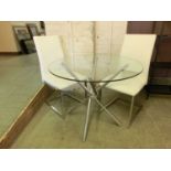 A chrome based glass topped circular table along with two chrome based leather upholstered chairs