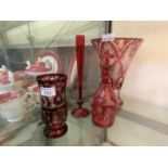 Four items of cranberry glassware to include decanter, etched glass vase, etc