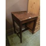 A mid-20th century child's wooden school desk with lift up lid