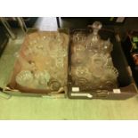 Two trays of assorted glassware to include decanters, bowls, drinking vessels etc.