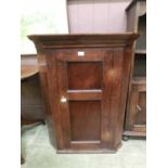 A 19th century oak wall mounted corner cupboard