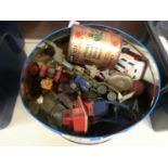 A tin containing an assortment of die cast vehicles to include ambulance, tractors, etc