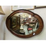 A walnut framed bevel glass mirror