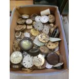 A box containing an assortment of pocket watch parts
