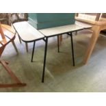 A 1960s Formica drop leaf kitchen table on black metal support