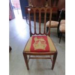 An early 20th century walnut framed single chair with royal needlework upholstery