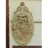 A resin moulded relief panel of cupids and angel