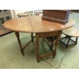 An early 20th century oak drop leaf table