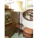 A mahogany carved and fluted standard lamp having a circular tray to base