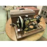 A walnut cased Rushby manual sewing machine