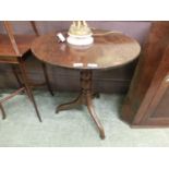 A 19th century tilt top single pedestal table