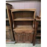 An early 20th century bookcase having linen fold doors to base