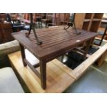 A weathered teak rectangular garden table