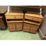 A pair of mid-20th century teak cabinets having single drawer above open storage above single door