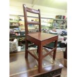 An early 20th century stained oak hall chair