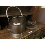 A coal scuttle together with a cast metal boot scrape