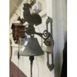 A wall hanging cast metal bell with cockerel design