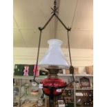 A red glass and metalwork light fitting