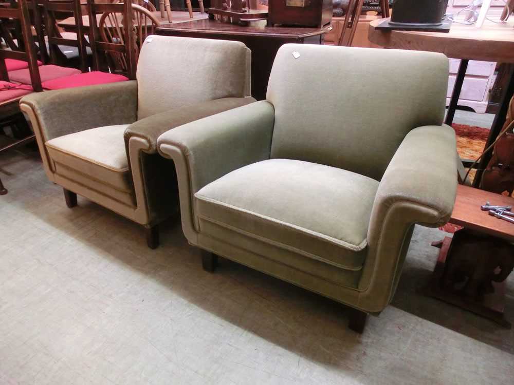 A pair of early 20th century easy chairs upholstered in an olive fabric