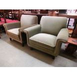 A pair of early 20th century easy chairs upholstered in an olive fabric