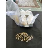 A box containing approximately 150 gold plated fishing hooks