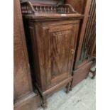 A mid-20th century stained pine single door cabinet with galleried top