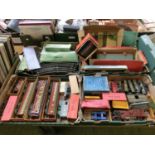 Four trays of 0 gauge tin plate railway items to include engines, track, carriages, etc
